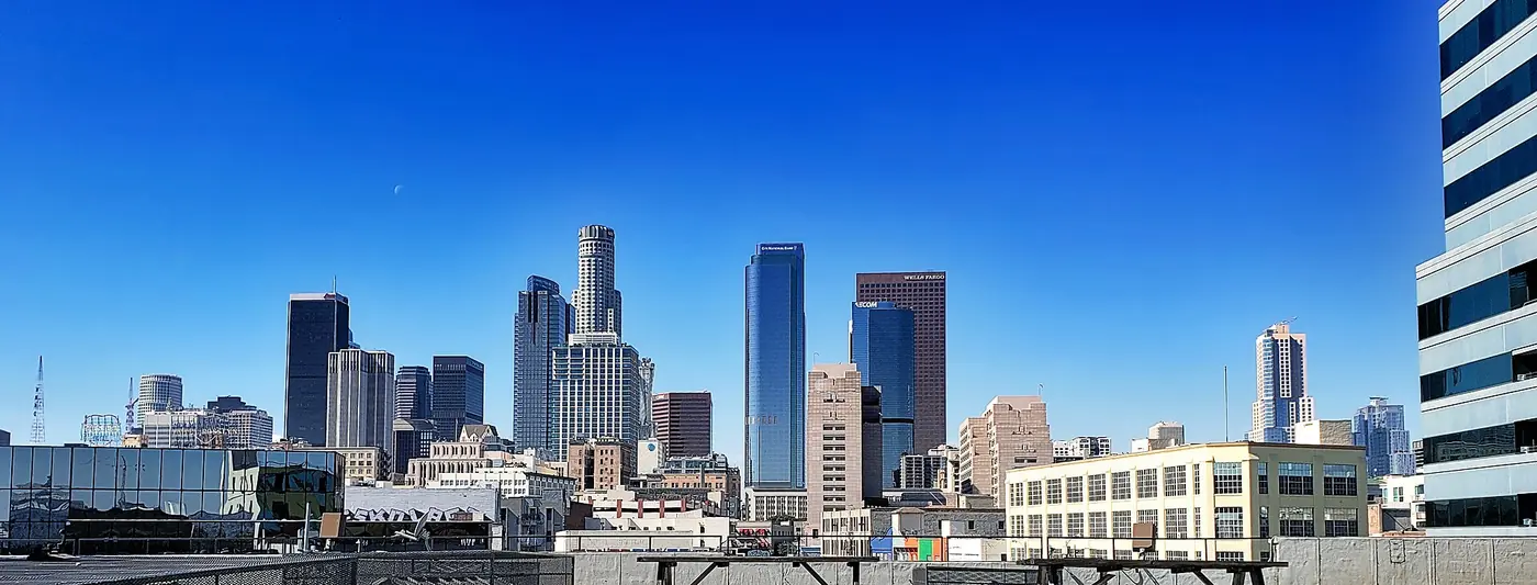 Downtown Los Angeles skyline under a blue sky